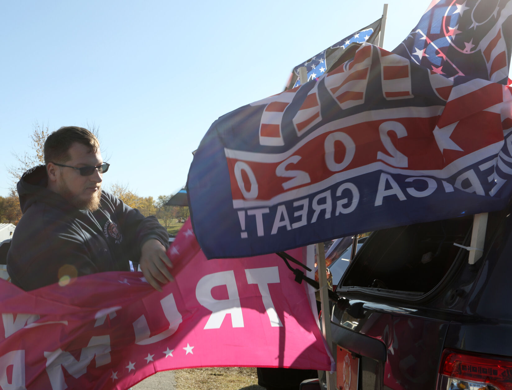 Travis Clark attaches flags to his vehicles